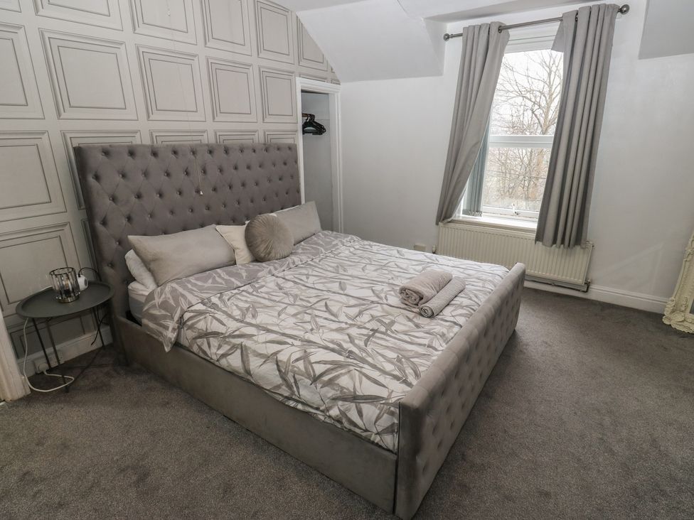 A bedroom with a bed and a window at Chestnut Lodge in Bradford