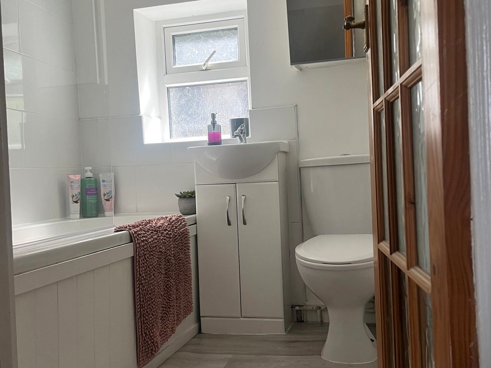 A bathroom with a sink, toilet and bath tub at Chestnut Lodge Bolton Woods near Shipley