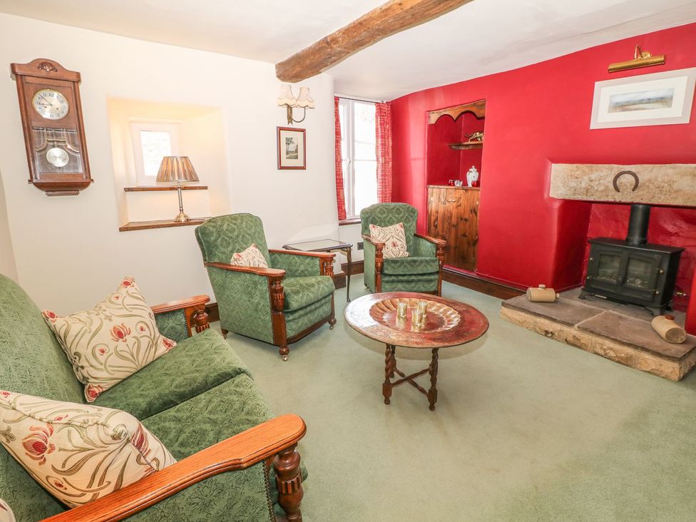 A living room with a fireplace and sofas at Little Bargate in Castleton, Peak District