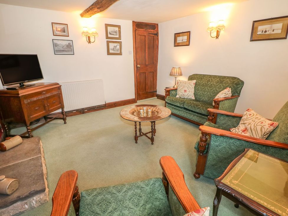 A living room with a television and seating area at Little Bargate in Castleton, Peak District