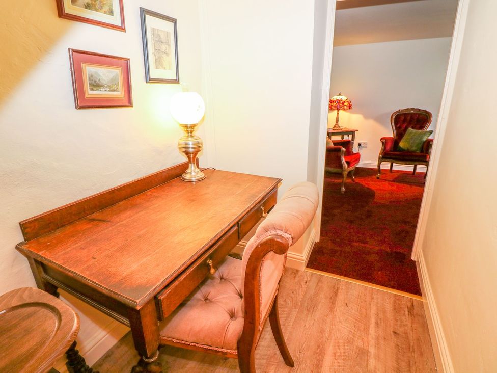 A hallway with a desk and lamp at Little Bargate in Castleton, Peak District