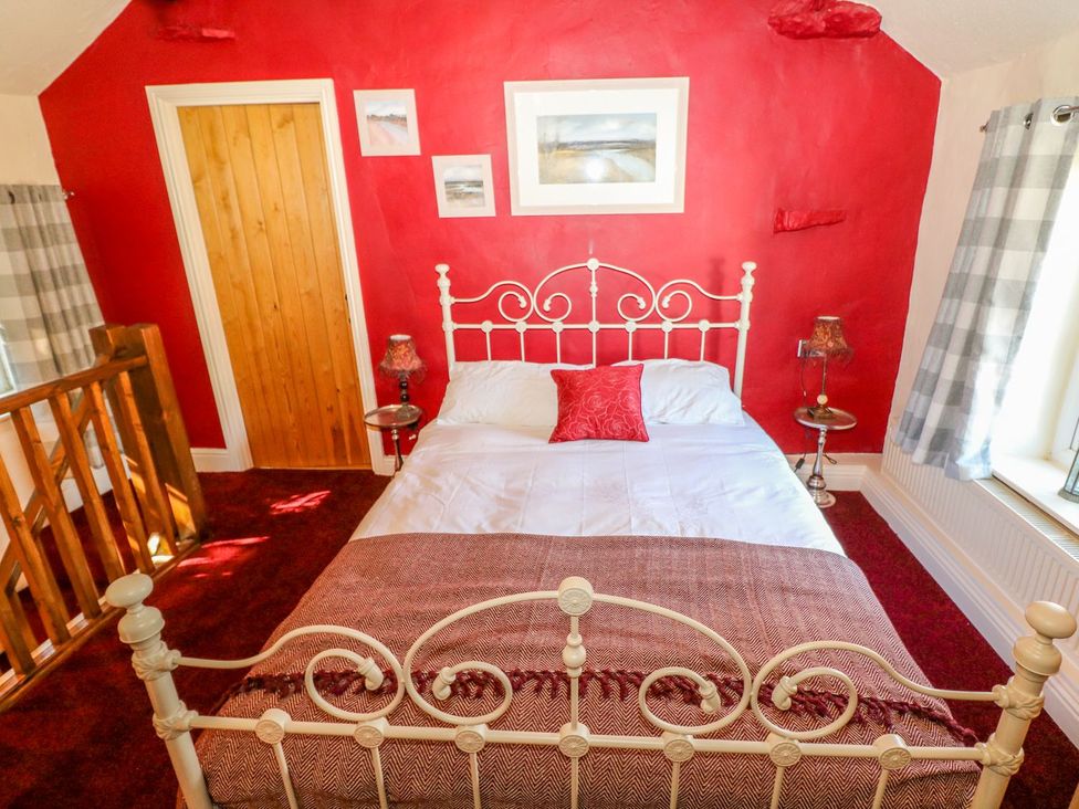 A bedroom with a bed and window at Little Bargate in Castleton, Peak District