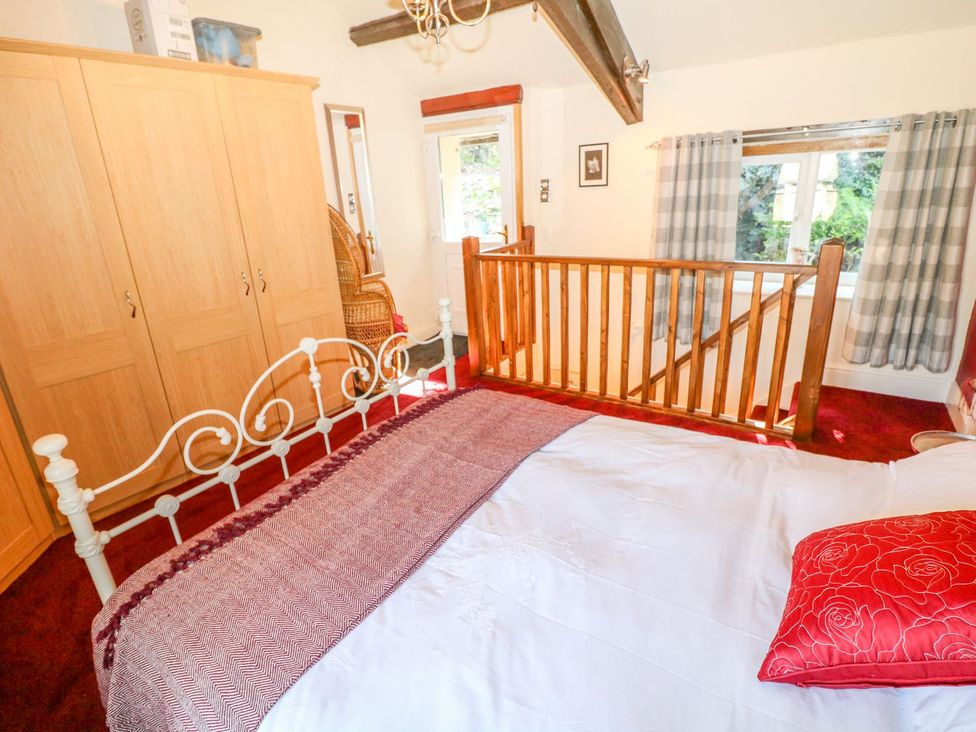 A bedroom with a bed and wardrobe at Little Bargate in Castleton, Peak District