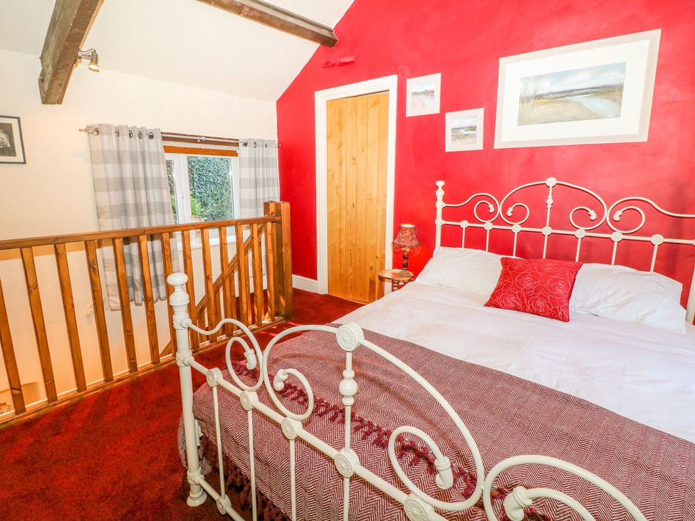 A bedroom with a bed and a window at Little Bargate in Castleton, Peak District