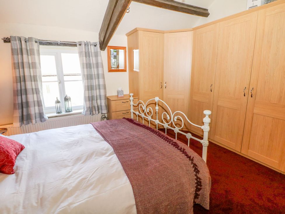 A bedroom with a bed and wardrobe at Little Bargate, Castleton, Peak District