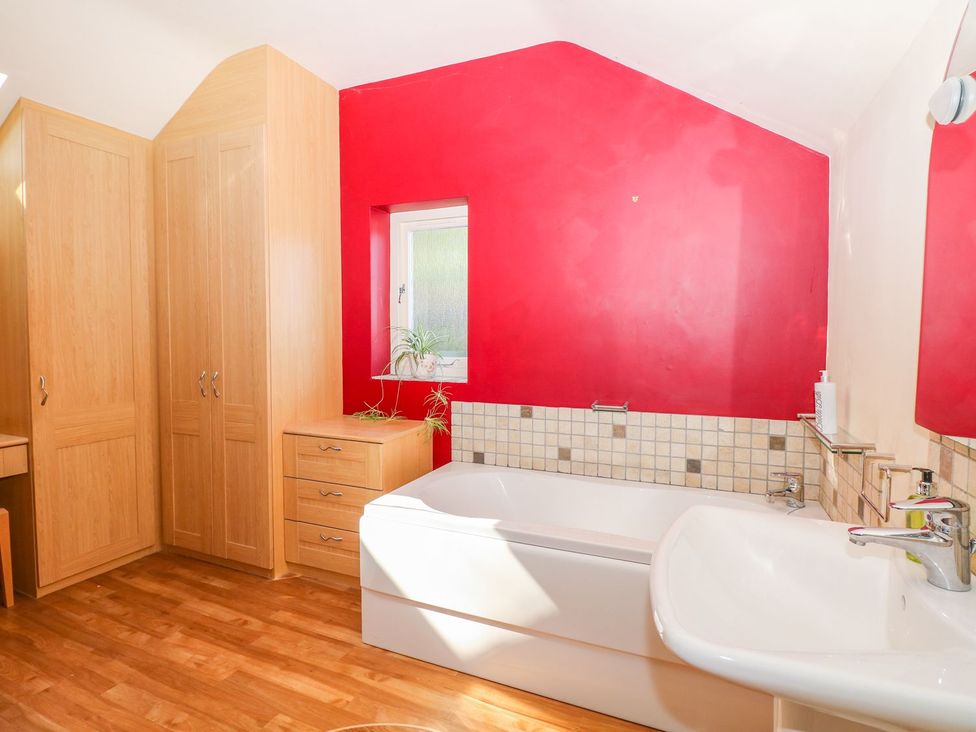 A bathroom with a bathtub and sink at Little Bargate, Castleton, Peak District