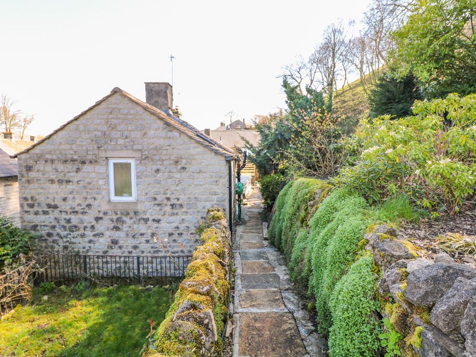 A pathway beside a stone house in the garden at Little Bargate Castleton, Peak District