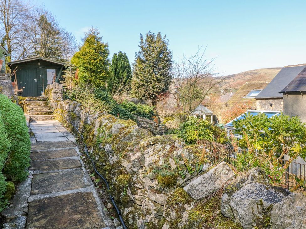 A garden pathway with a stone wall and shed at Little Bargate in Castleton, Peak District