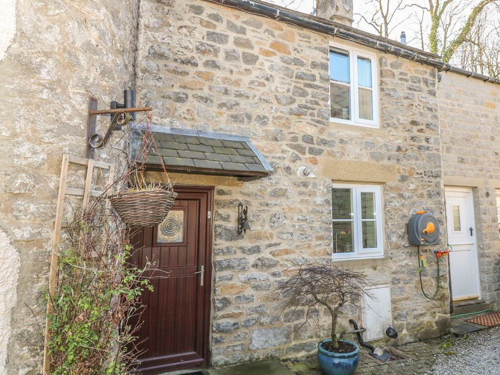 An exterior view of a stone cottage with door and windows at Little Bargate, Castleton, Peak District