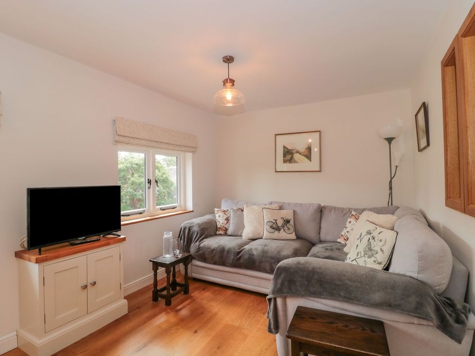 A living room with a sofa and television at Greenham Rise in Norton-Sub-Hamdon