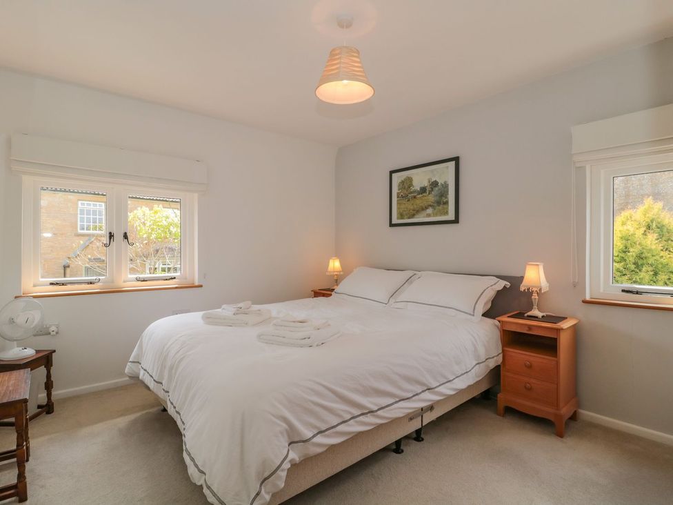 A bedroom with a bed and nightstands at Greenham Rise in Norton-Sub-Hamdon