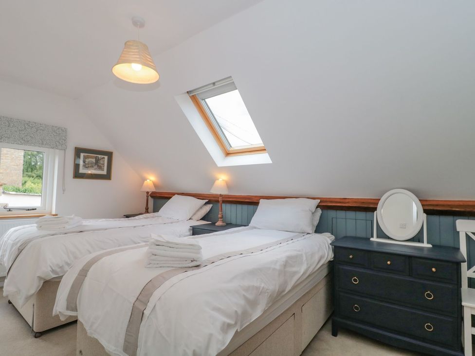 A bedroom with two beds and a window at Greenham Rise in Norton-Sub-Hamdon