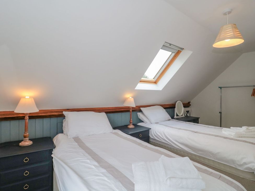 A bedroom with two beds and a skylight at Greenham Rise in Norton-Sub-Hamdon