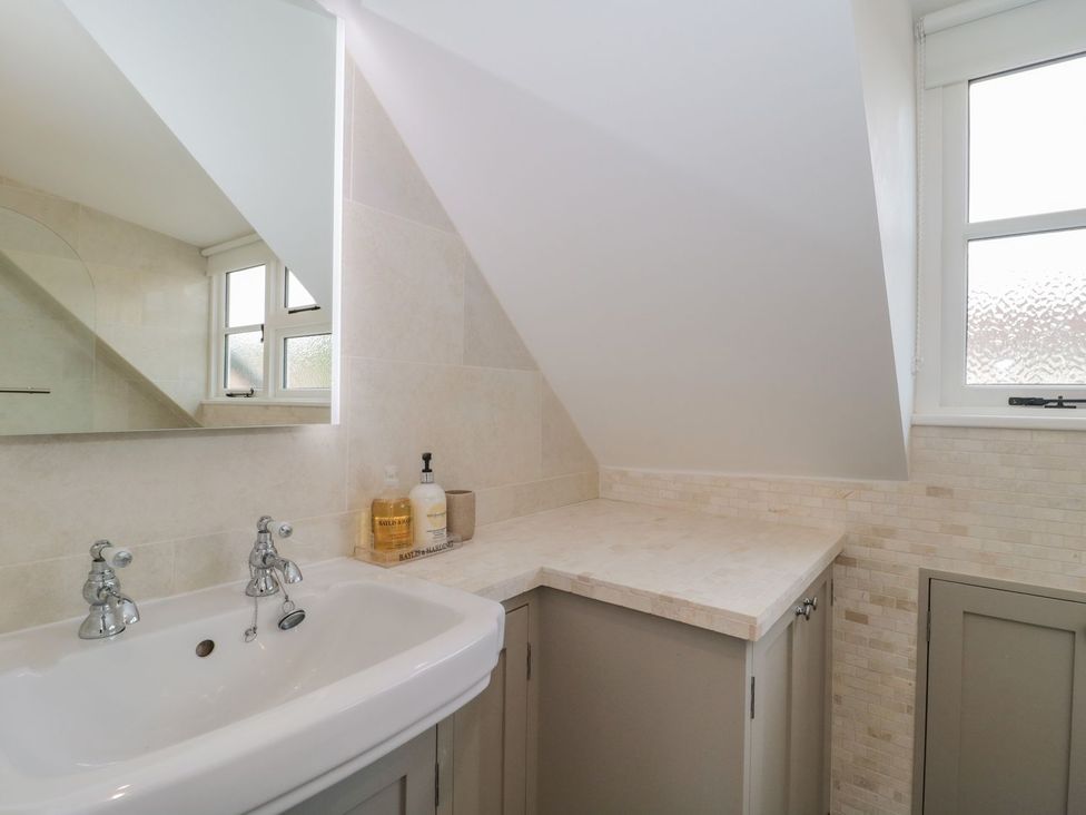 A bathroom with a sink and cabinet at Greenham Rise in Norton-Sub-Hamdon