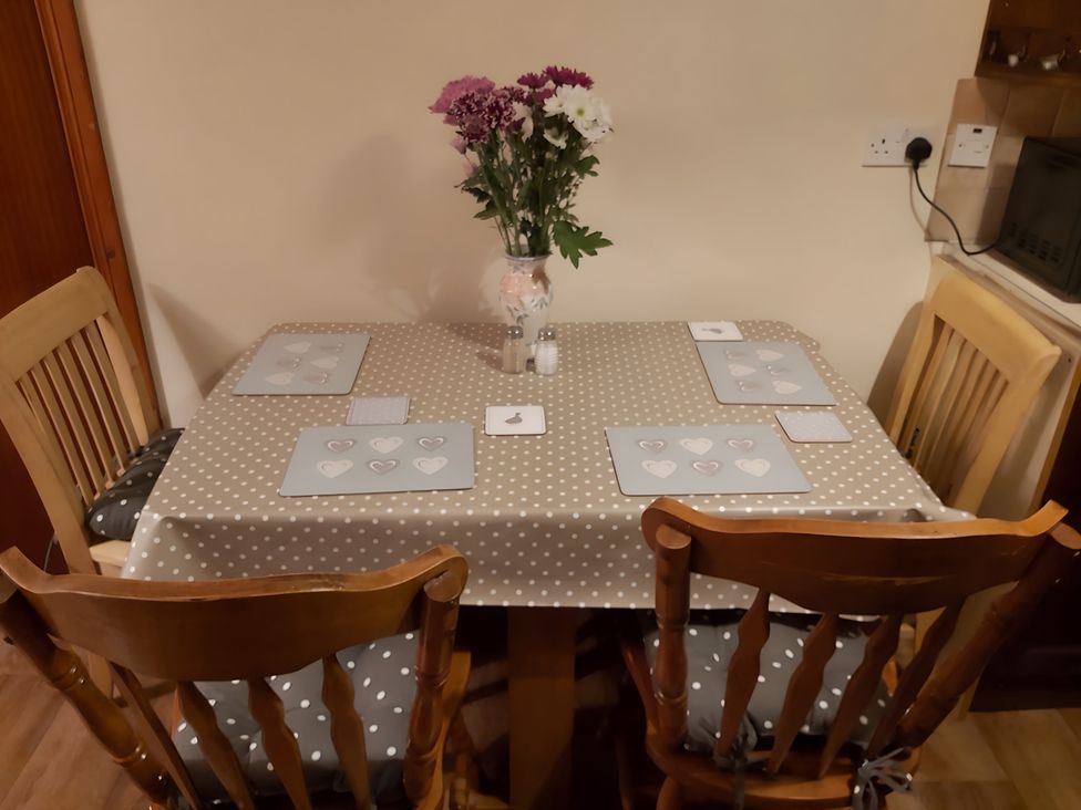 A dining room table with flowers and place mats at 87 Ballyveaghmore Road in Newry