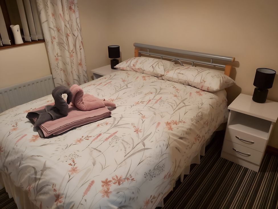 A bedroom with a bed and towels on it at 87 Ballyveaghmore Road in Newry