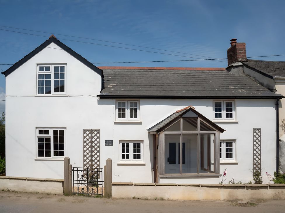 A house with a front door and windows at The Cottage in Helston