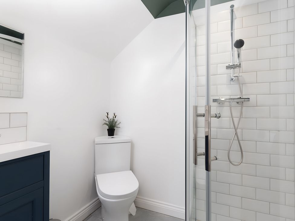 A bathroom with a shower and sink at The Cottage in Helston