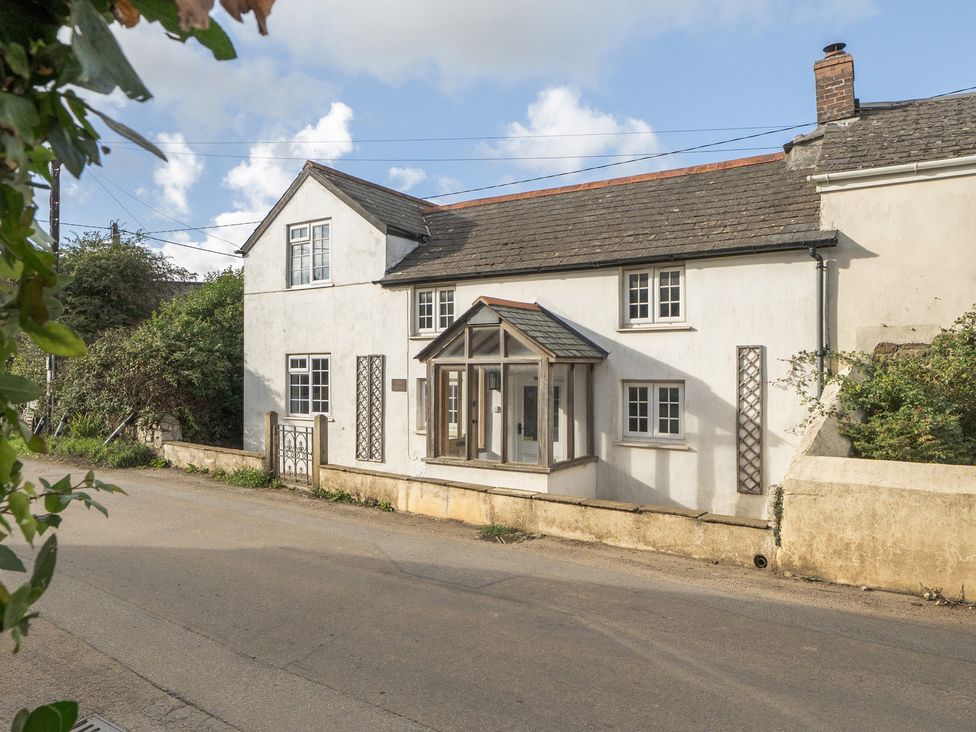 A house with windows and a front door at The Cottage in Helston