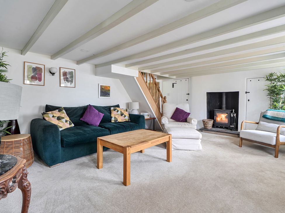 A living room with a sofa and coffee table at The Cottage in Helston