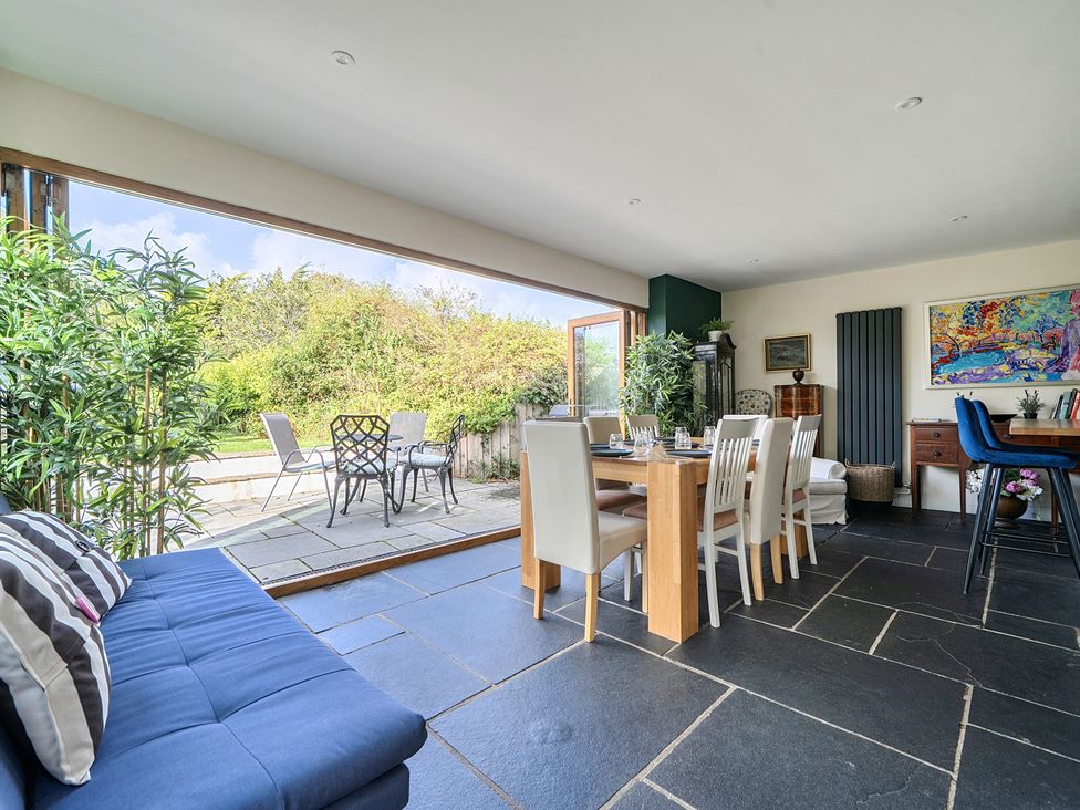 A dining room with a table and chairs at The Cottage in Helston