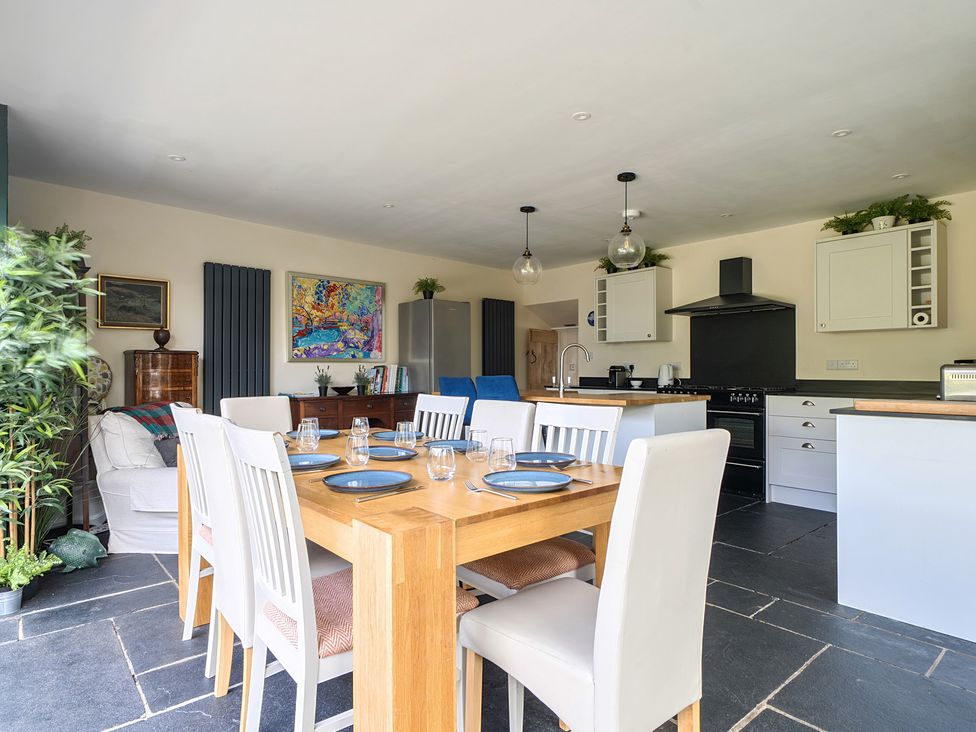 A kitchen with dining table and chairs at The Cottage in Helston