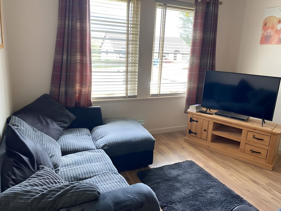 A living room with a sofa and television at 9 Creag An Iolaire Near Portree