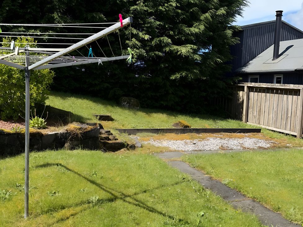 A garden with a washing line and gravel area at 9 Creag An Iolaire near Portree