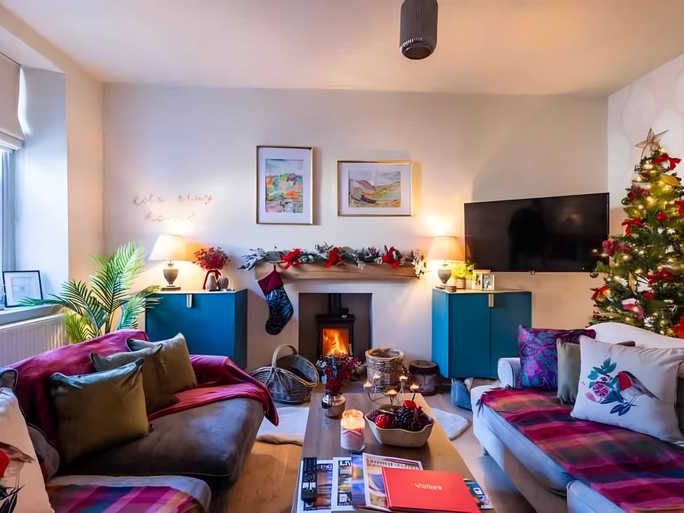 A living room with a Christmas tree and fireplace at 29 Chapel Street Appleby-In-Westmorland