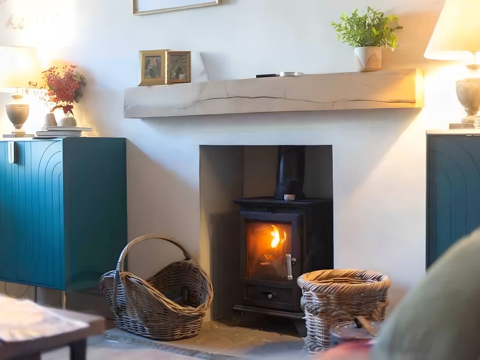 A living room with a fireplace and storage cabinets at 29 Chapel Street Appleby-In-Westmorland