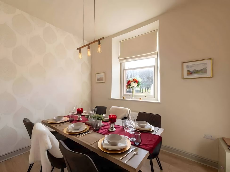 A dining room with a table set for a meal at 29 Chapel Street Appleby-In-Westmorland