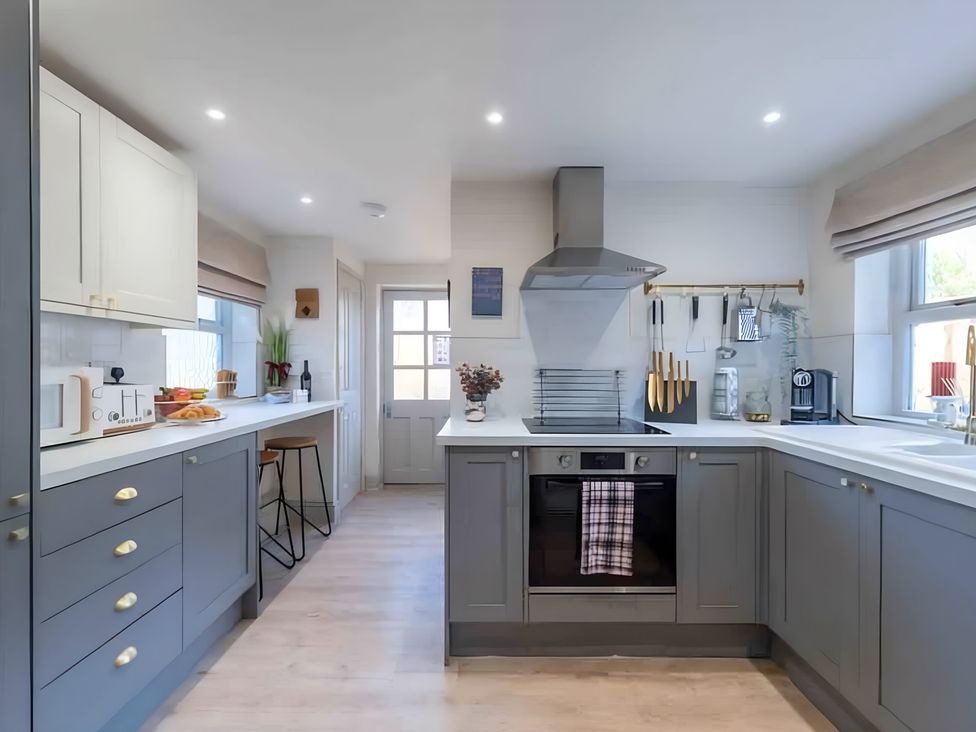 A kitchen with cabinets and appliances at 29 Chapel Street in Appleby-In-Westmorland