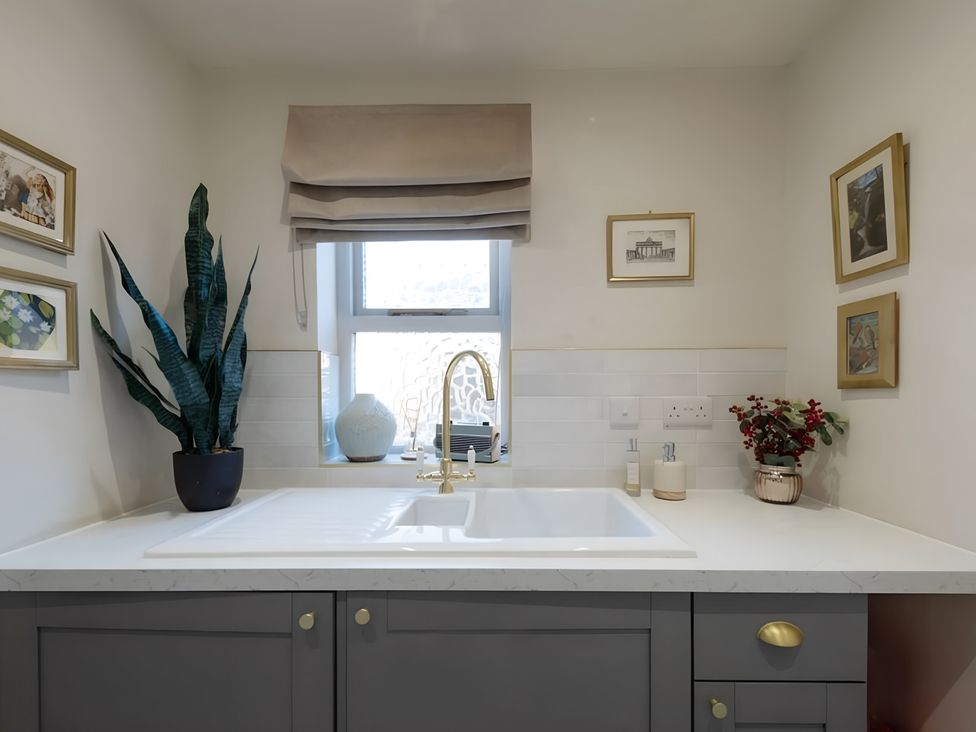 A kitchen with a sink and faucet at 29 Chapel Street Appleby-In-Westmorland