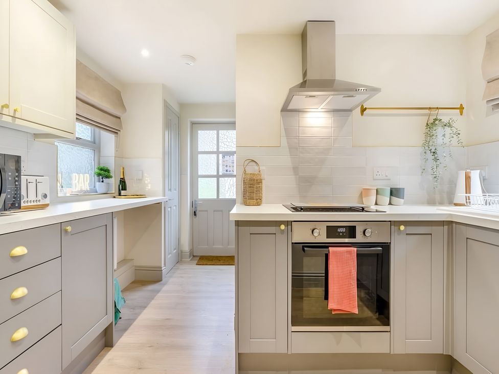 A kitchen with cabinets and appliances at 29 Chapel Street Appleby-In-Westmorland