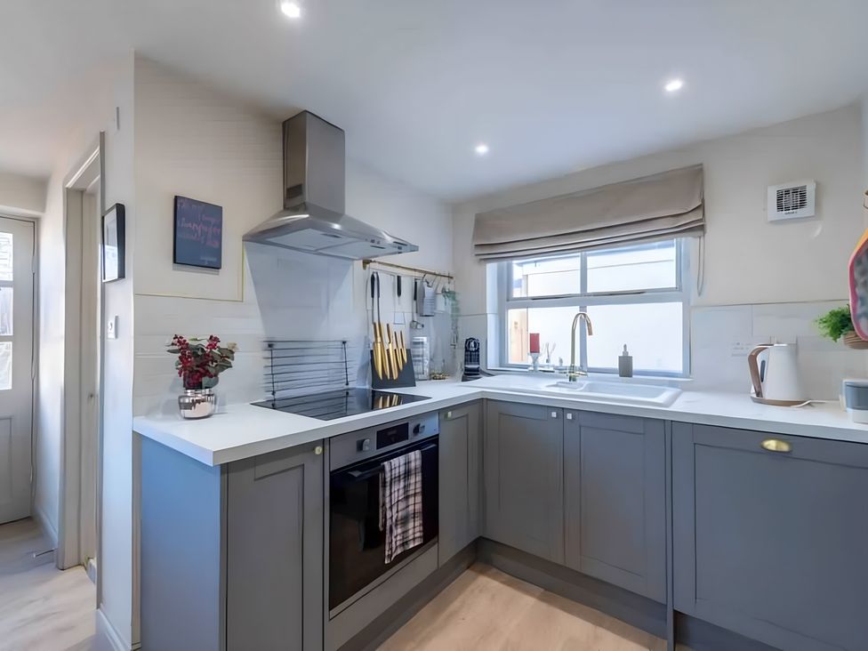 A kitchen with cabinets and appliances at 29 Chapel Street Appleby-In-Westmorland
