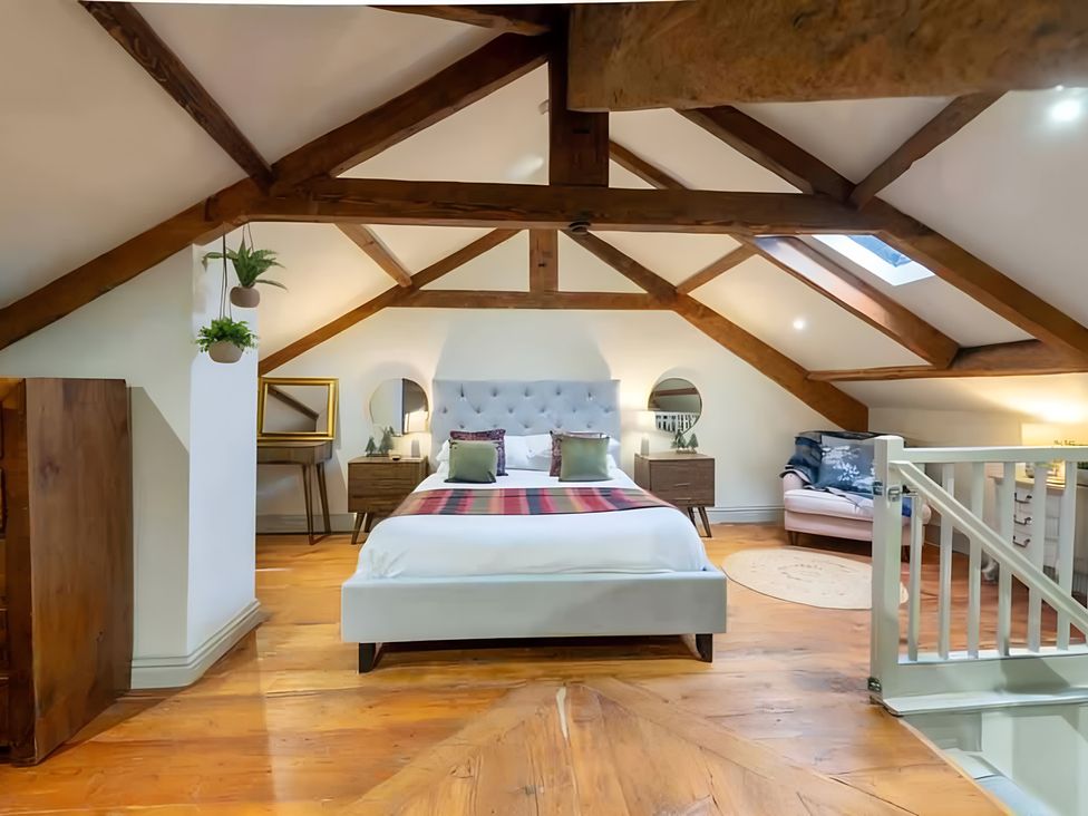 A bedroom with a bed and nightstands at 29 Chapel Street in Appleby-In-Westmorland