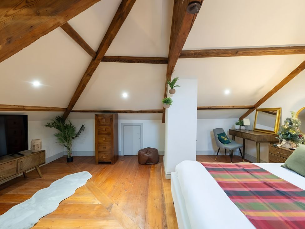 A bedroom with a bed and wooden furniture at 29 Chapel Street in Appleby-In-Westmorland