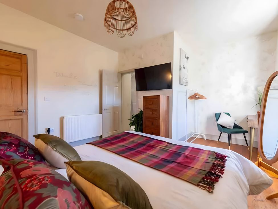 A bedroom with a bed and television at 29 Chapel Street Appleby-In-Westmorland