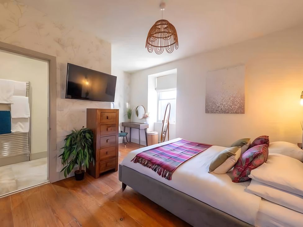 A bedroom with a bed and television at 29 Chapel Street in Appleby-In-Westmorland
