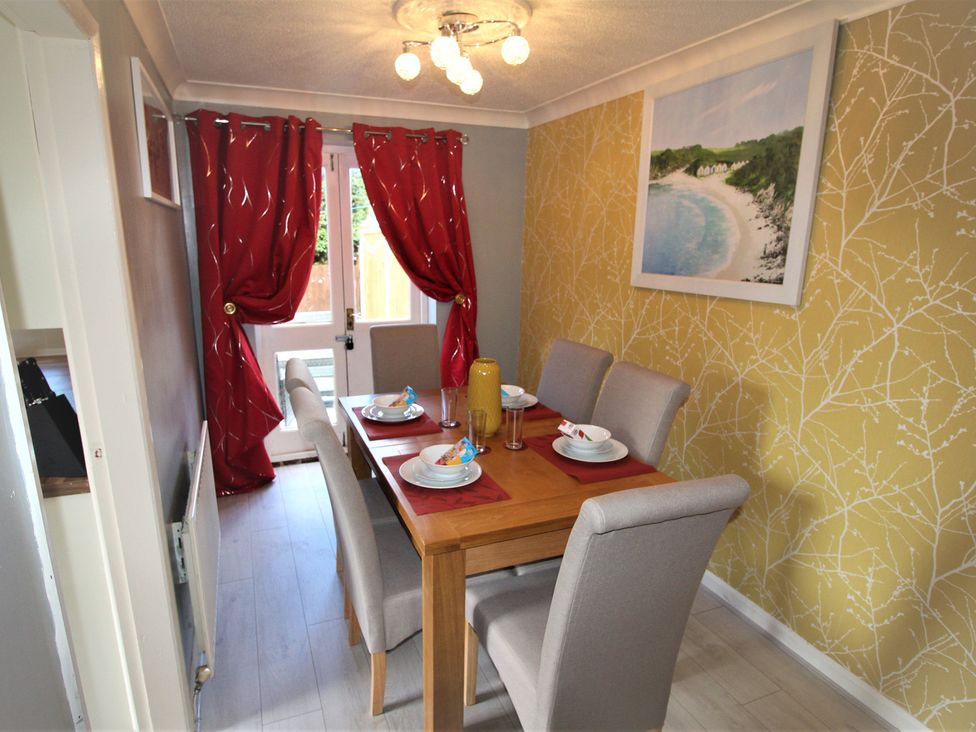 A dining room with a table set for meals at 41 St. Georges Road Doncaster