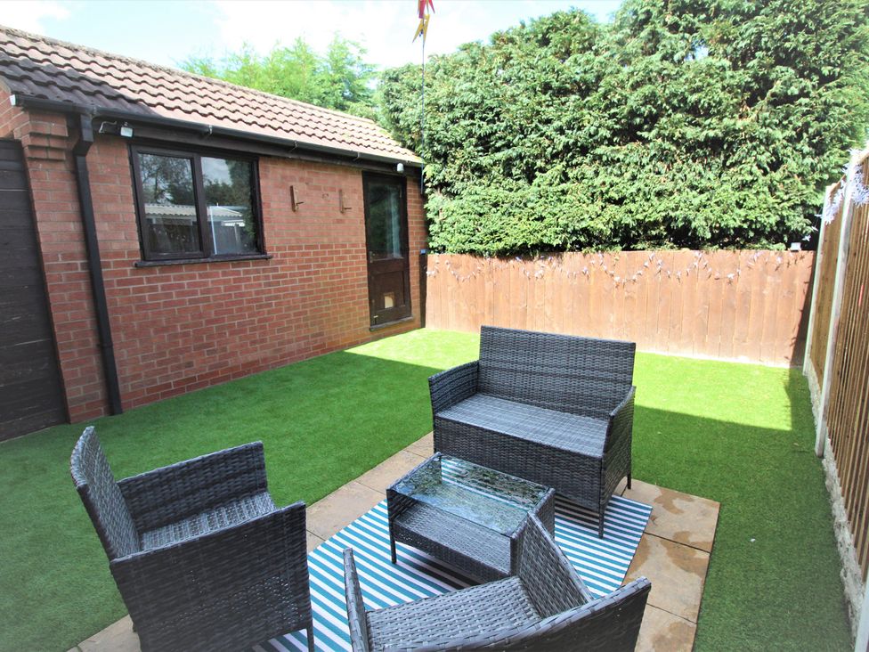 A garden with seating area and glass table at 41 St. Georges Road, Doncaster