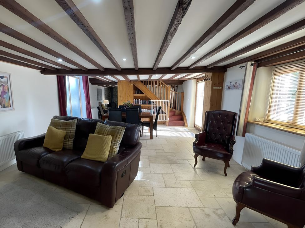 A living room with a sofa and armchair at Granary Barn in Winkleigh
