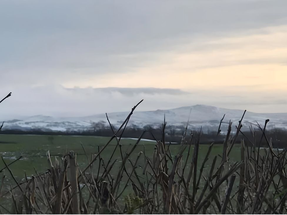 A view of mountains and grass in the foreground at Granary Barn in Winkleigh