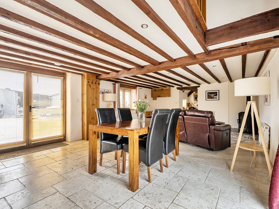 A dining room with a table and chairs at Granary Barn in Winkleigh