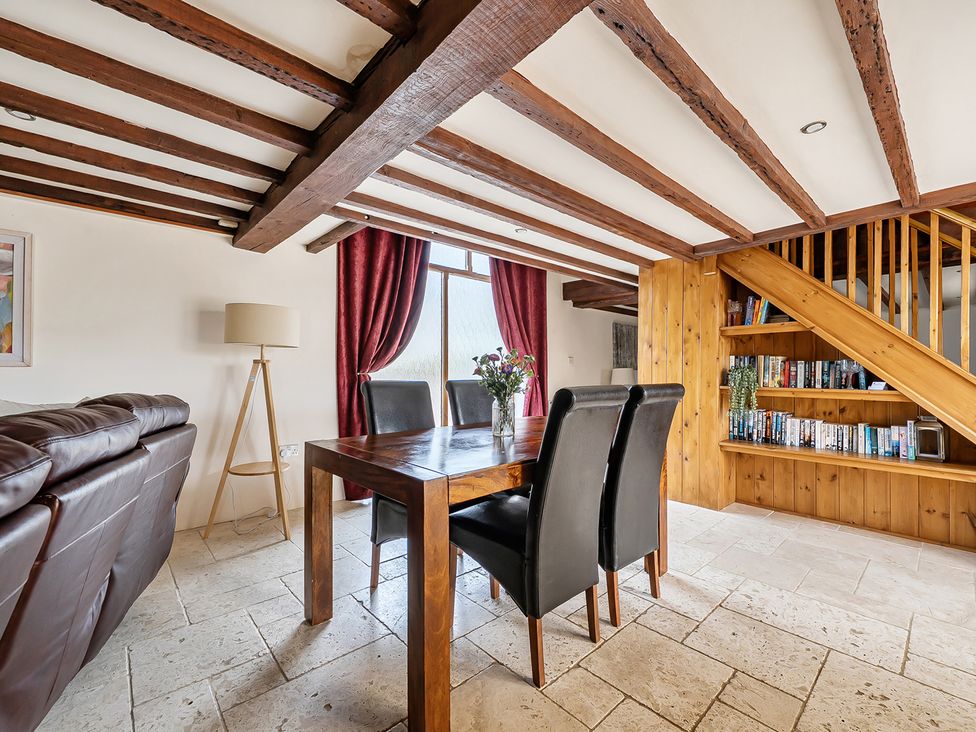 A dining room with a table and chairs at Granary Barn in Winkleigh