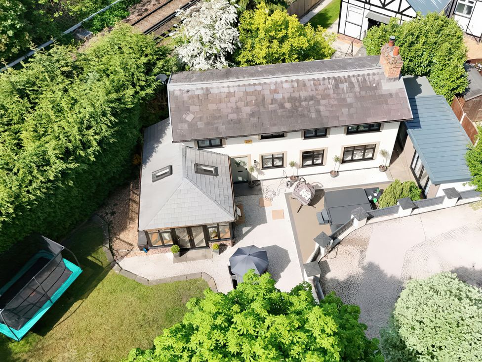 A house with a yard and trampoline at Rainbow Cottage in Ormskirk