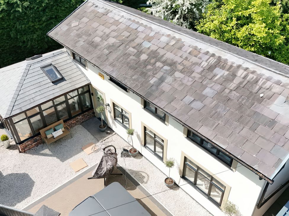 An outdoor area with a view of a house and garden at Rainbow Cottage in Ormskirk