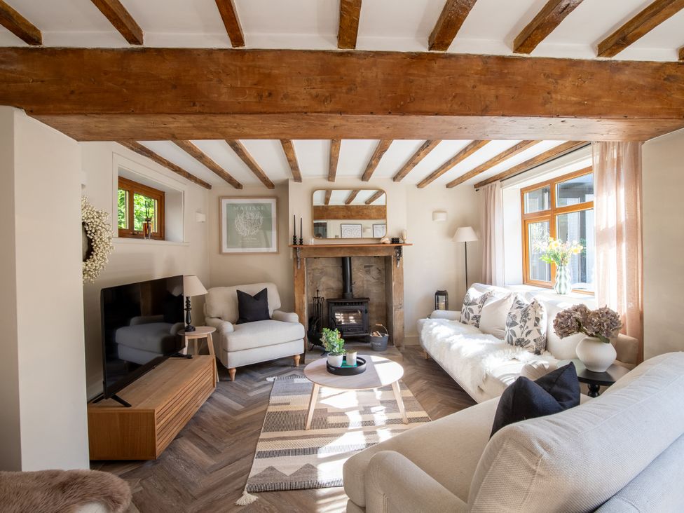 A living room with a sofa and coffee table at Rainbow Cottage in Aughton near Ormskirk
