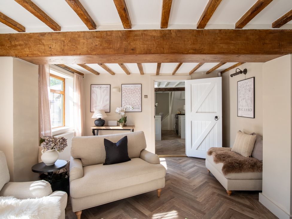 A living room with two sofas and wall art at Rainbow Cottage in Aughton near Ormskirk