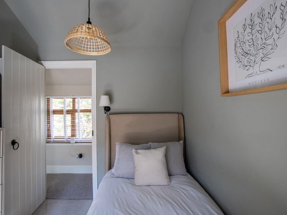 A bedroom with a bed and lamp at Rainbow Cottage Aughton near Ormskirk